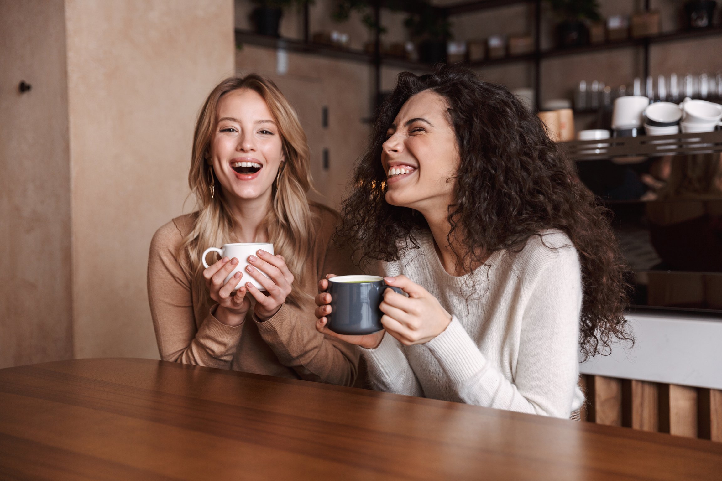 Friends Sitting in Cafe Talking and Laughing